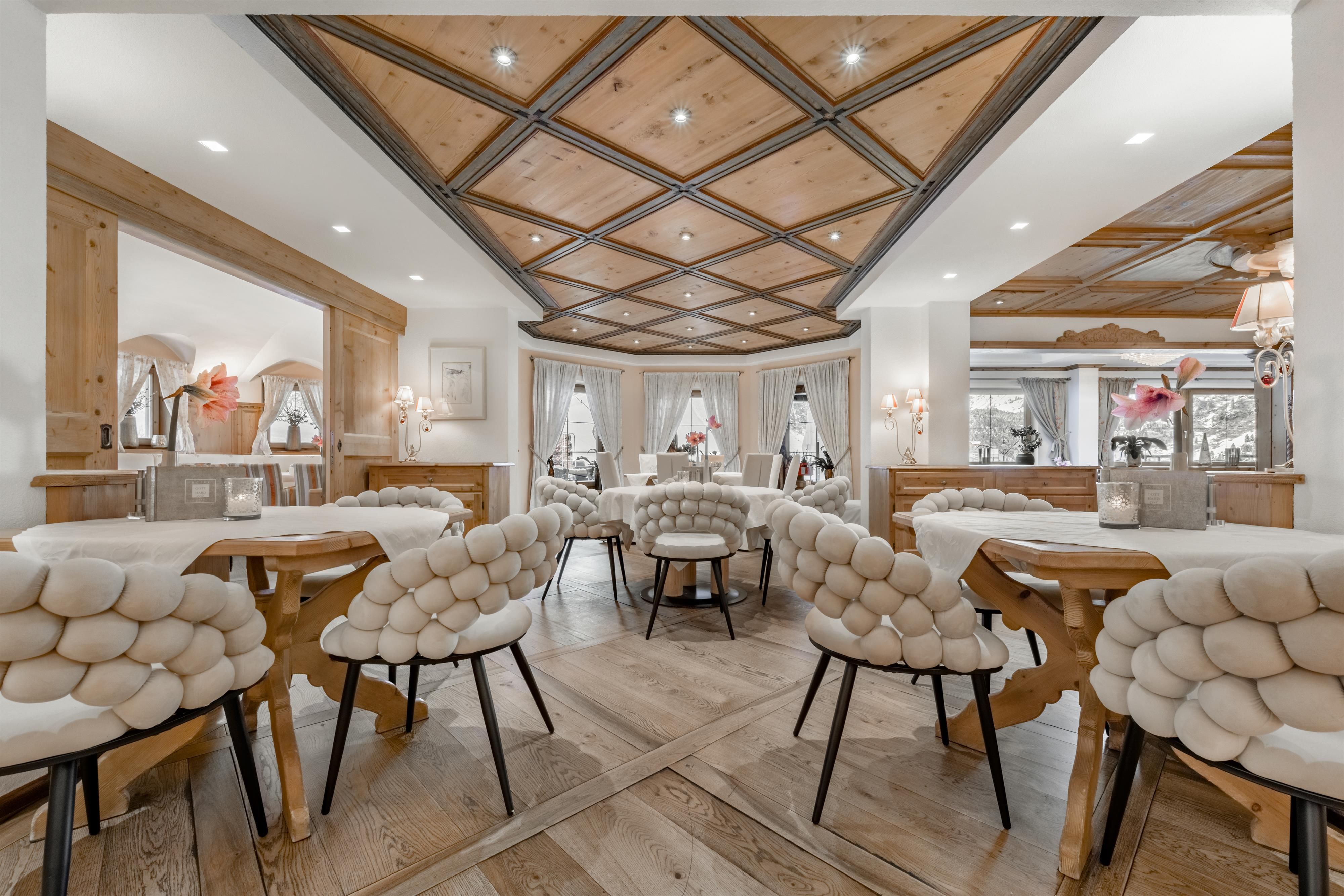 An elegant restaurant with wooden floors and stylish furniture. The atmosphere is warm and inviting.