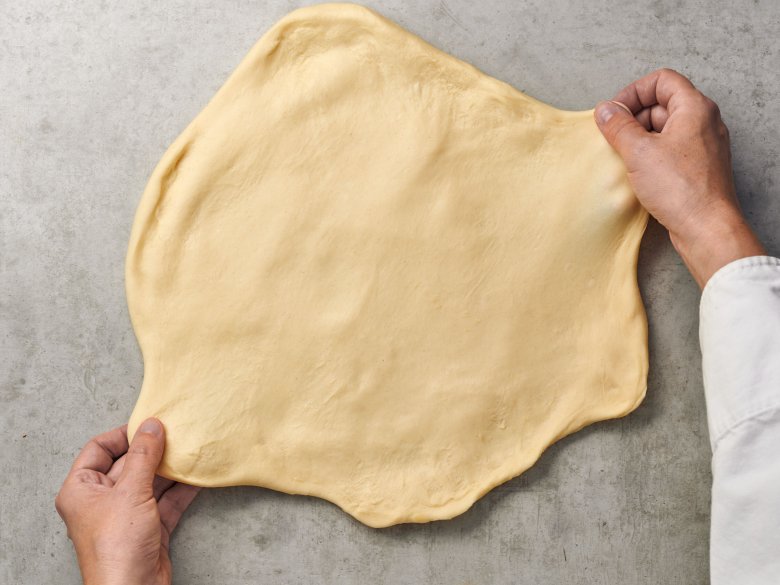 Step 4: Work the dough with your hands until it is thin and even.