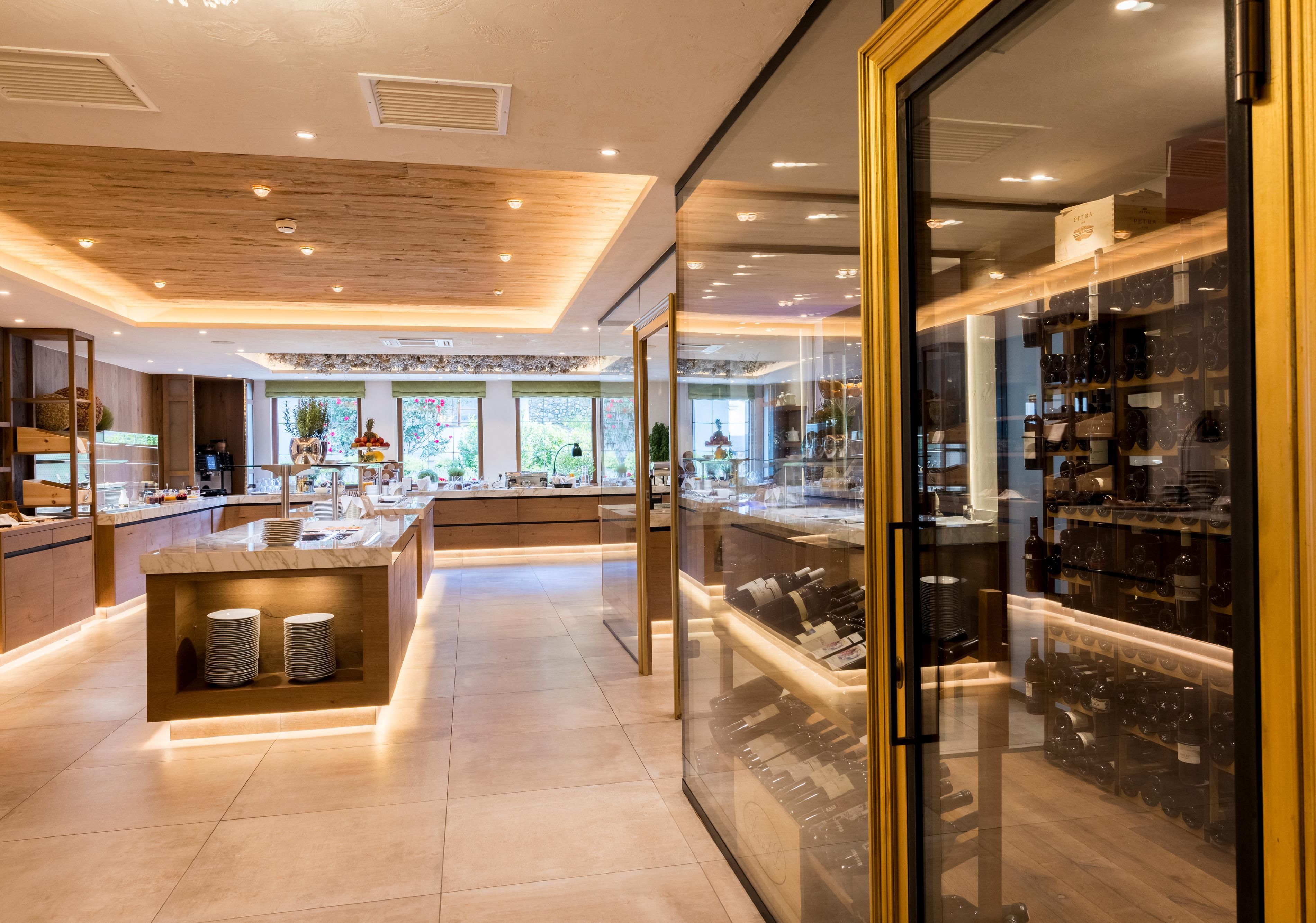 A stylish buffet area with a modern design. The illuminated shelves display a selection of food and drinks.