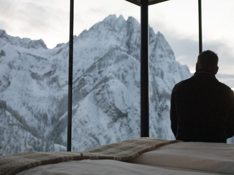 One of the most beautiful rooms in Tirol? The floor-to-ceiling windows at the Dolomitenh&uuml;tte offer spectacular mountain views.
