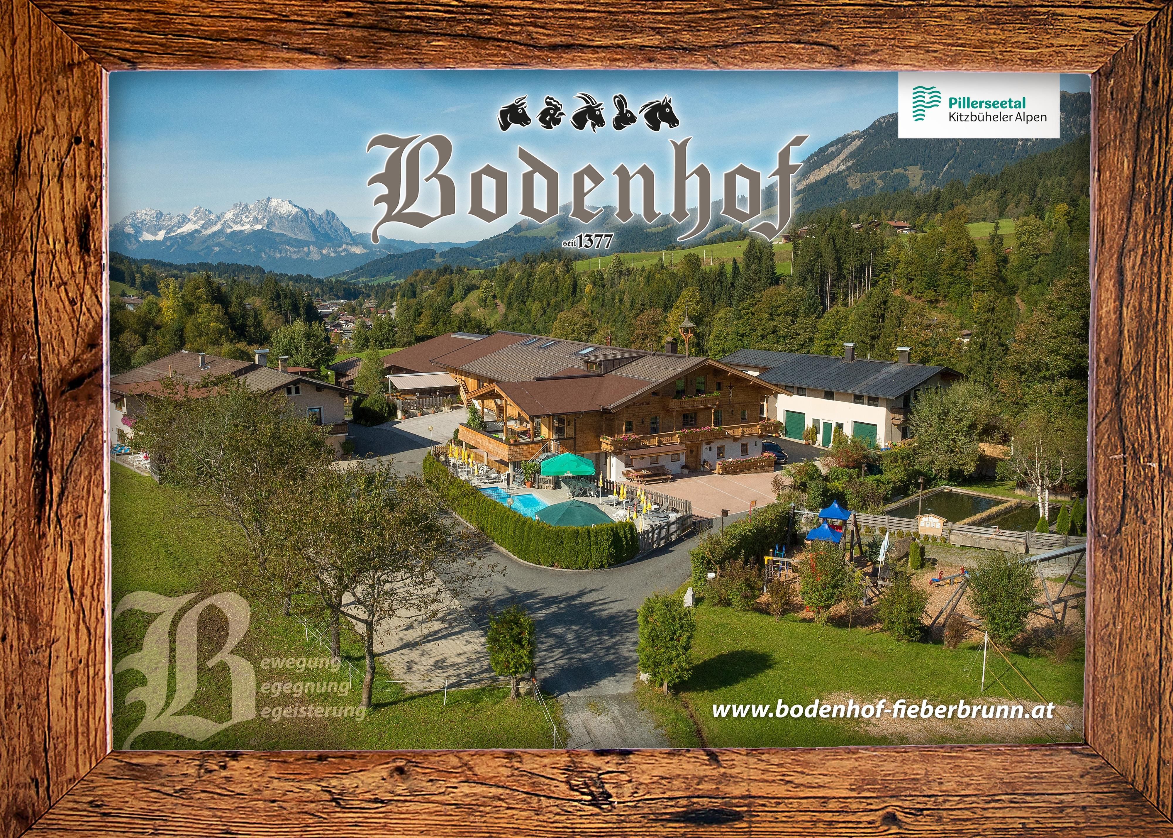 A beautiful view of the courtyard with a mountain backdrop in the background. The facility offers an inviting atmosphere with a garden and pool.