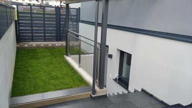 The apartment has a terrace with garden