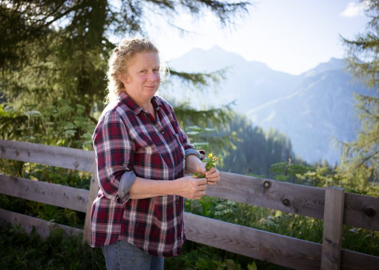 Ingrid Schl&ouml;gl, who runs the Trunah&uuml;tte, collects herbs in the area around the hut.
