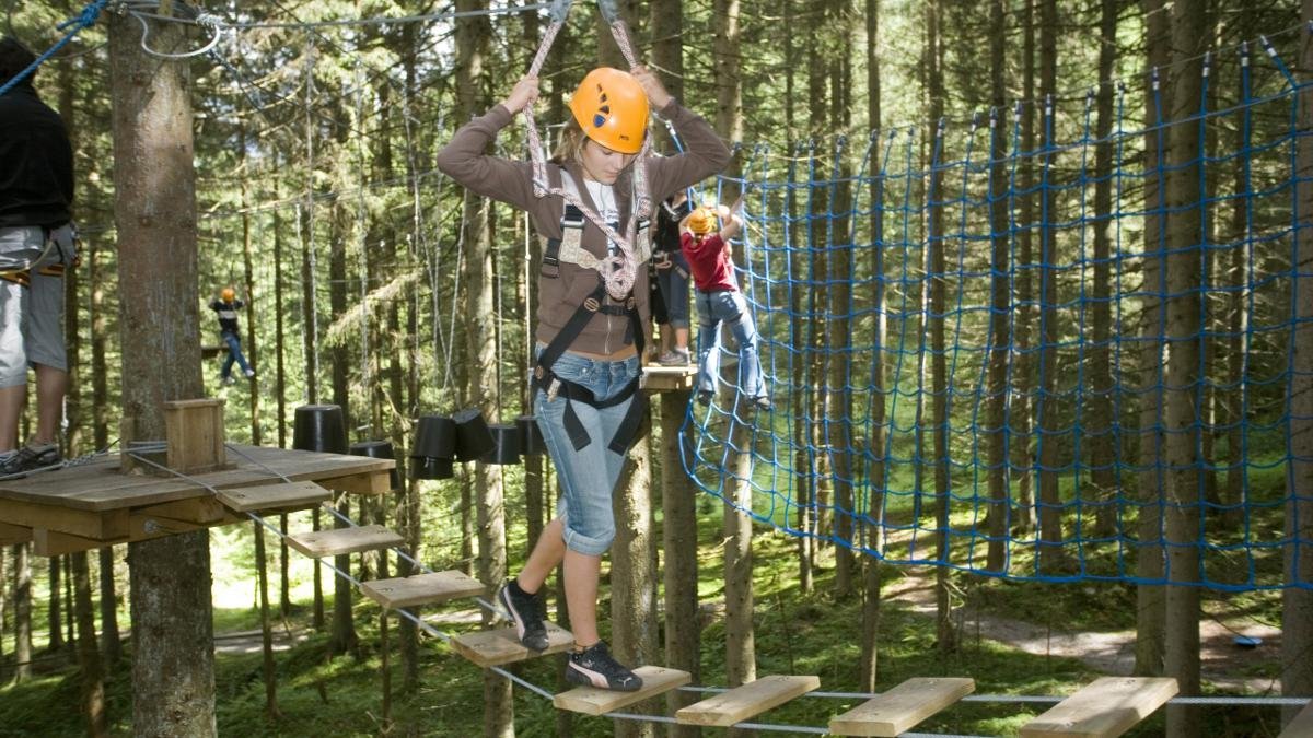 At the Hochseilgarten Gerlos visitors of all ages can test their nerves and balance on a series of platforms between 10 and 15 metres above the ground. They are connected by ropes and wires to form a giant obstacle course comprising no fewer than 70 separate platforms. The children's course has ten platforms closer to the ground., © Zillertal Arena